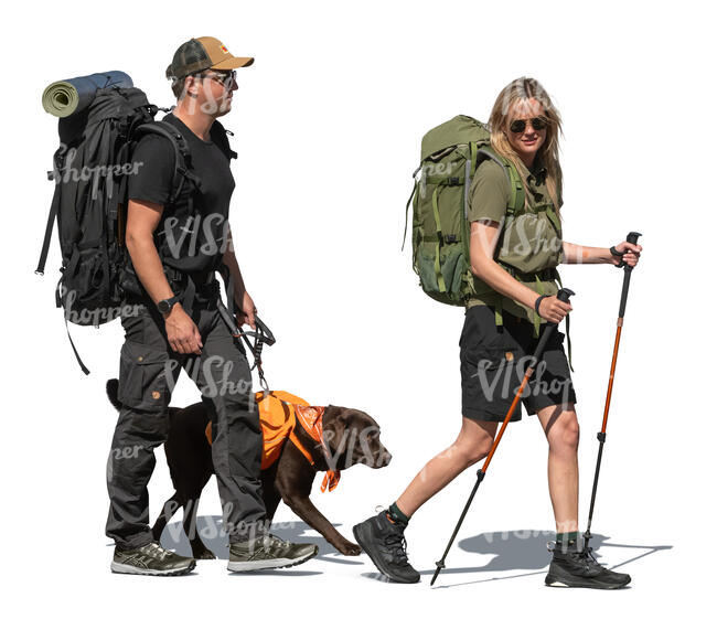 two cut out hikers with backpacks and a dog walking