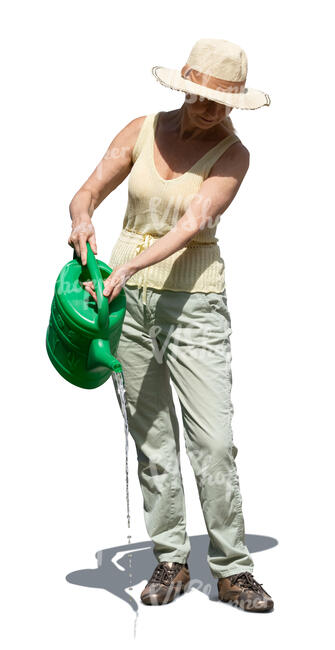 senior woman watering plants in the garden