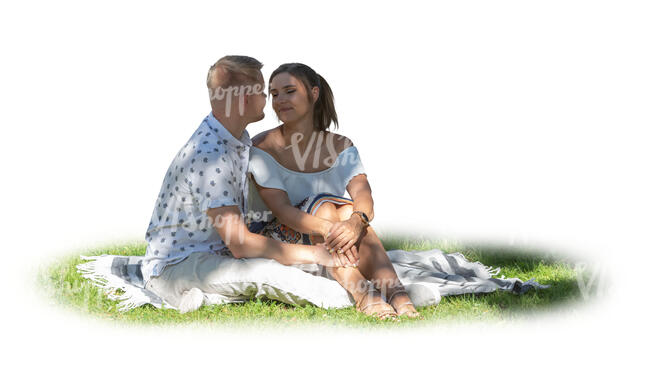 cut out couple sitting on the grass under a tree