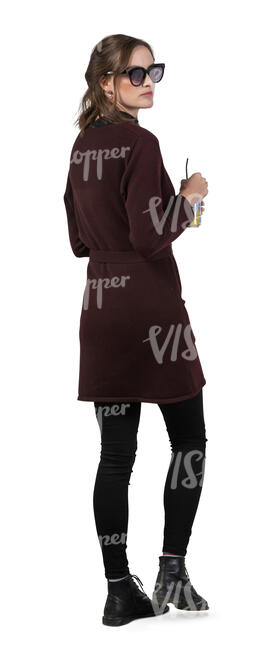 woman standing and drinking a soft drink