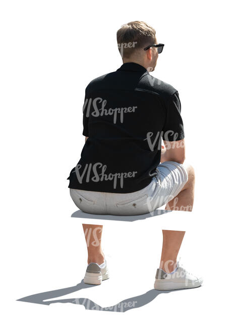 backlit man sitting seen from back angle