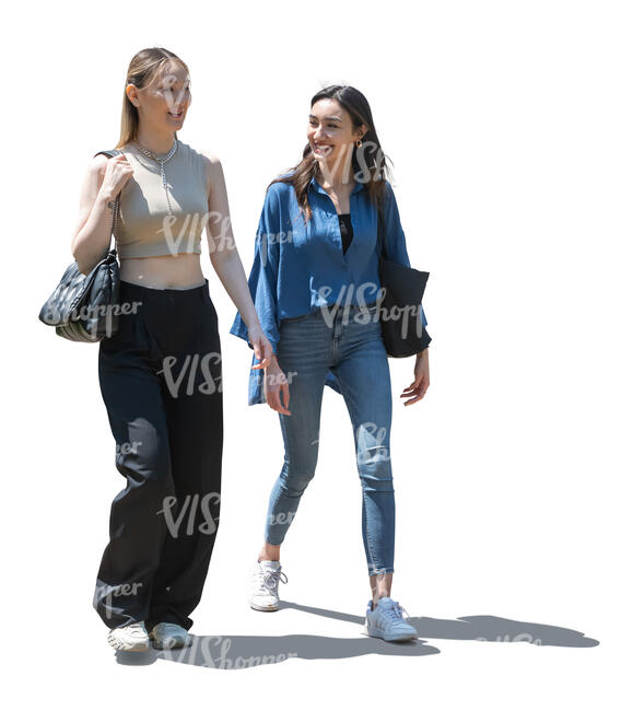 two backlit women walking and talking