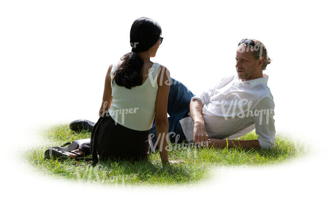two people relaxing outside in the park on the grass