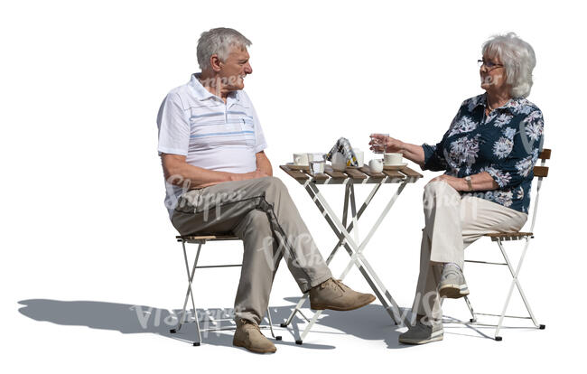 cut out elderly couple sitting in an outdoor cafe