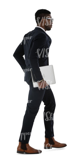 black businessman in a sleek black suit walking