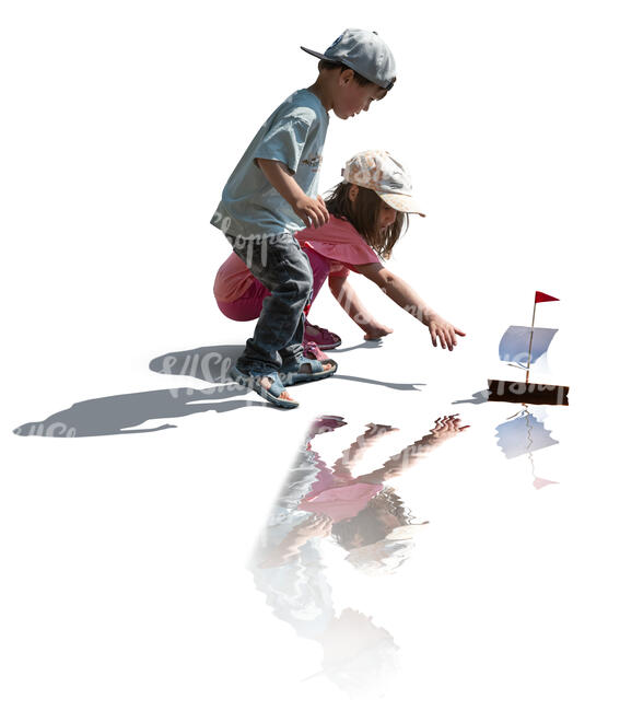 two cut out kids floating a toy boat