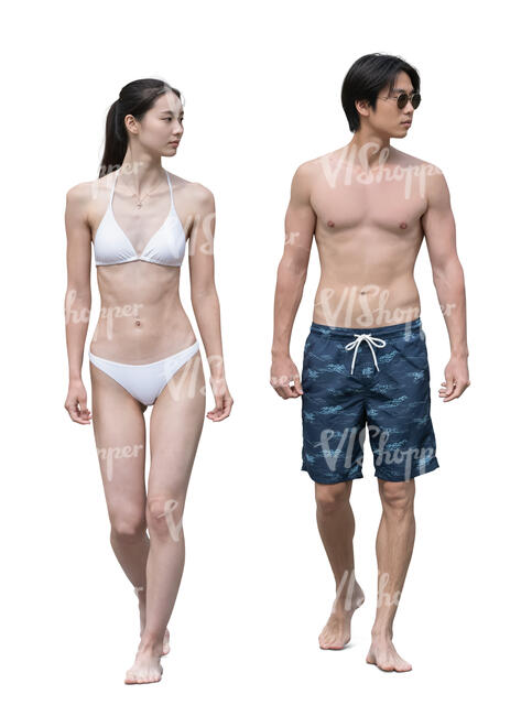 asian man and woman walking at the beach