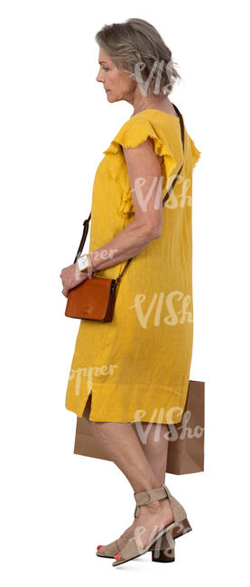 mature woman with a shopping bag walking
