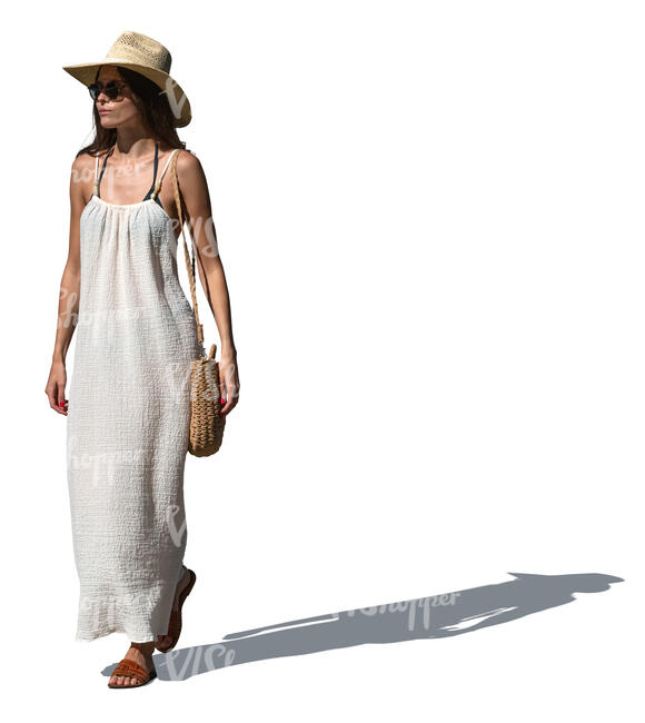woman with a hat and summer dress walking