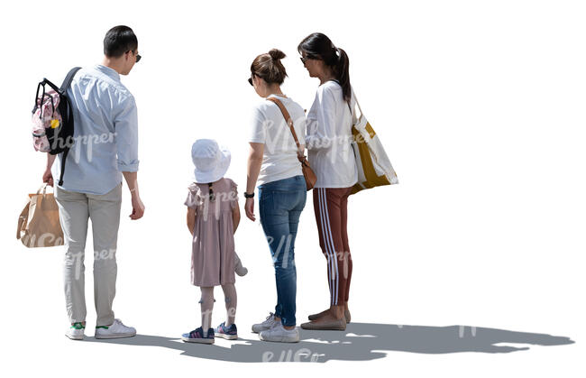 backlit group of adults and a child standing