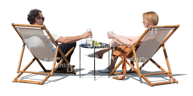 man and woman sitting on outdoor chairs