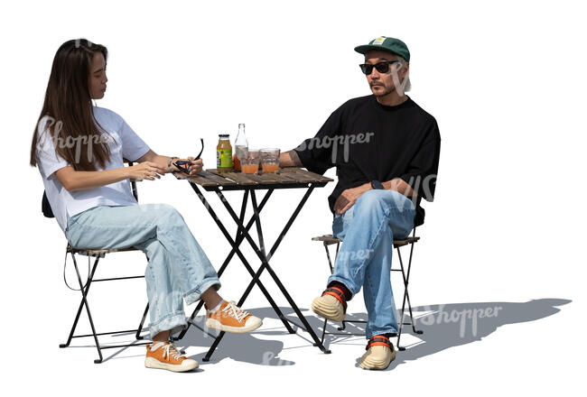 asian woman and man sitting in a street cafe in summer