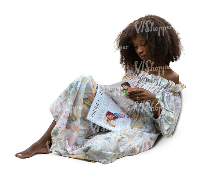 black woman sitting on a sofa and reading a magazine