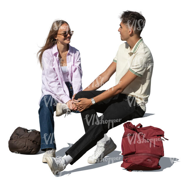 two teenagers sitting and talking