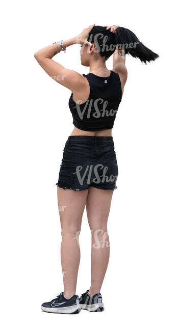 woman standing and adjusting her hair