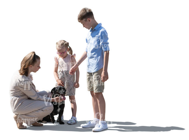 Three children petting a dog