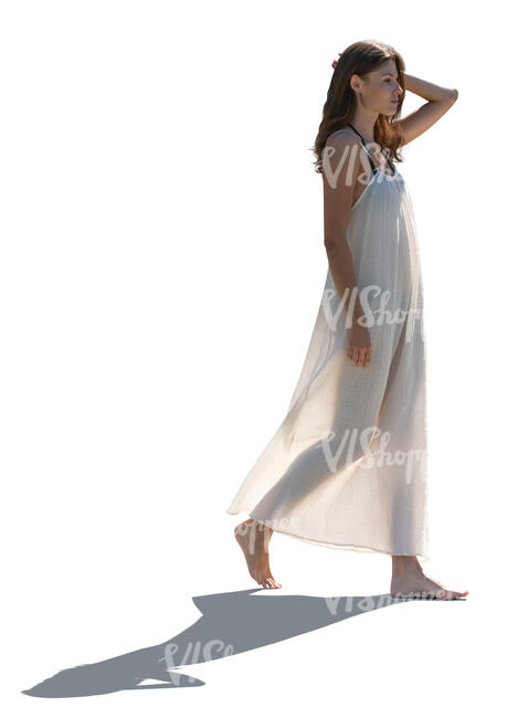 woman in a light beach dress walking barefoot