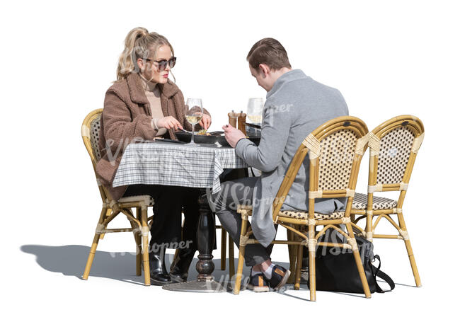 man and woman eating in an outdoor restaurant