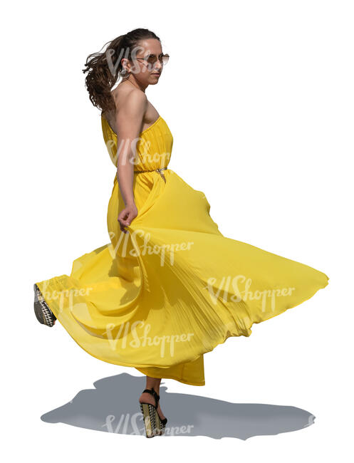 cut out woman in a long yellow dress twirling and dancing
