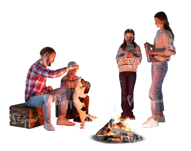 family with a dog sitting around the bonfire