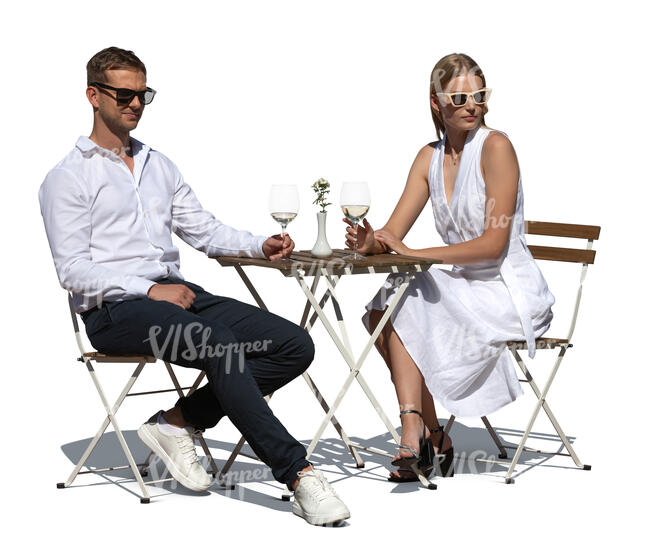 fancy couple sitting in an outdoor restaurant and drinking wine