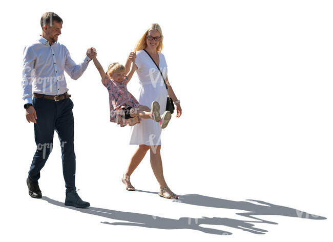 backlit family with parents holding their daughter by hands