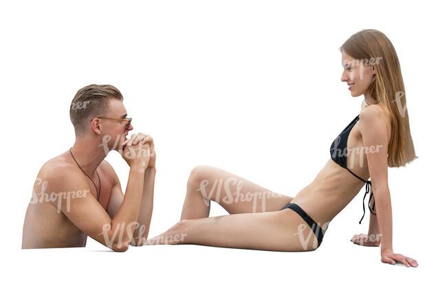 man in a pool talking to a woman sunbathing by the pool