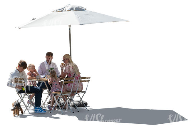 family with kids sitting in an outdoor restaurant under a parasol