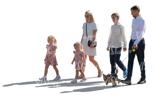 backlit family with kids and a dog walking