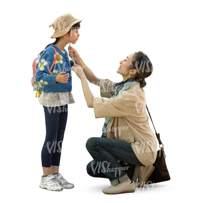 cut out japanese woman putting a hat on her little daughter