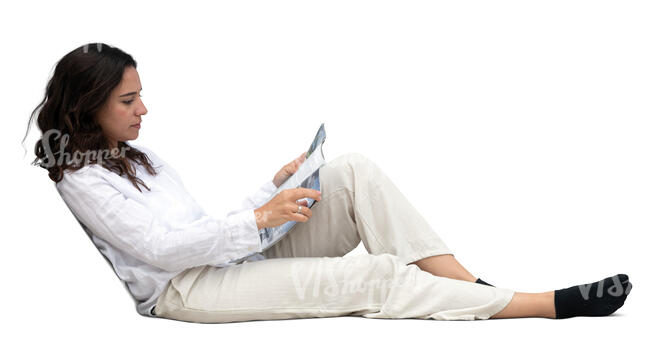 woman sitting on a sofa and reading a magazine