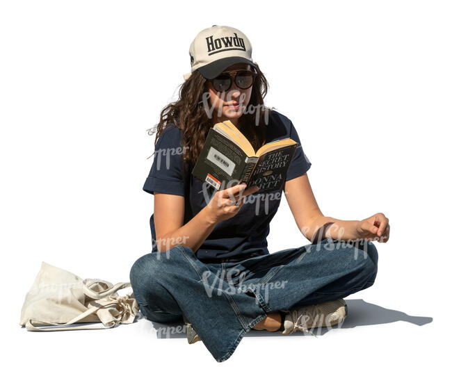 woman sitting outside and reading a book