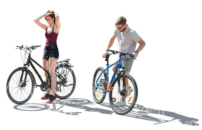 backlit man and woman on bikes stopping