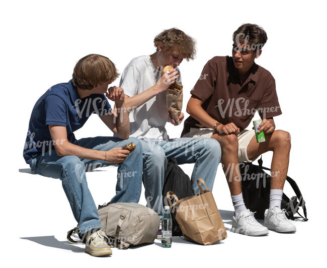 group of boys sitting on a bench and eating lunch