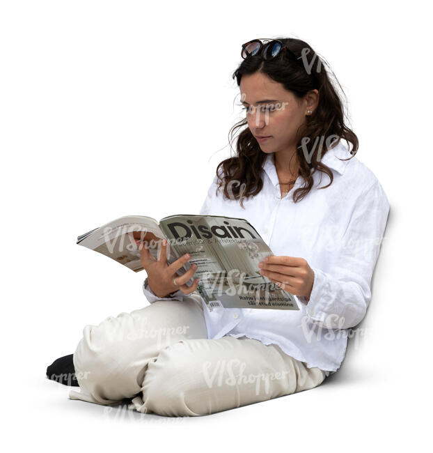woman sitting on a sofa and reading a magazine