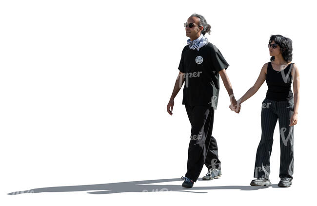 backlit image of and indian couple walking hand in hand