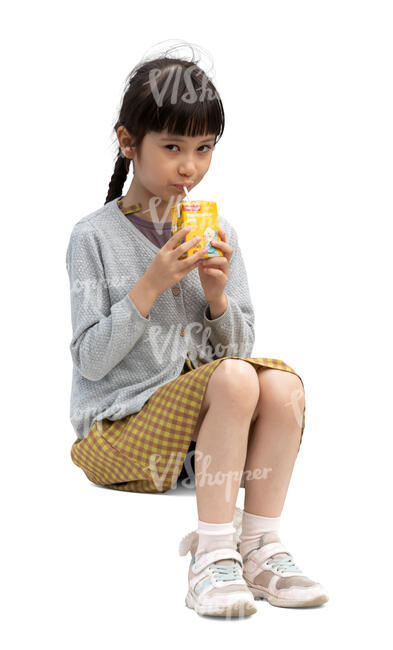 little japanese girl sitting and drinking juice