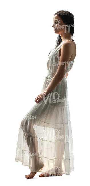 woman in a semi-sheer white dress standing in a doorway