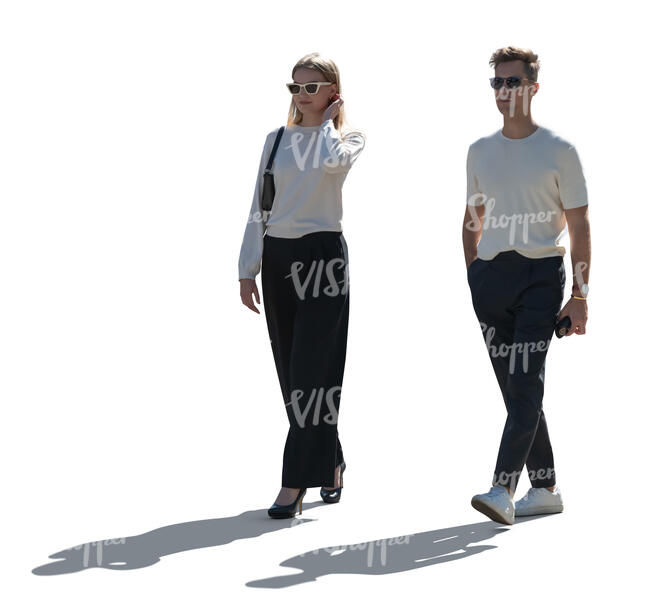 man and woman walking in backlight