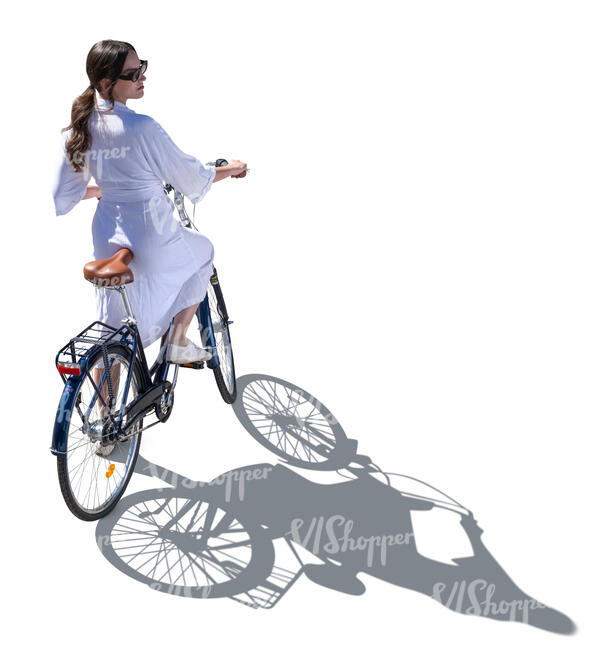 woman in a white dress riding a bike seen from above