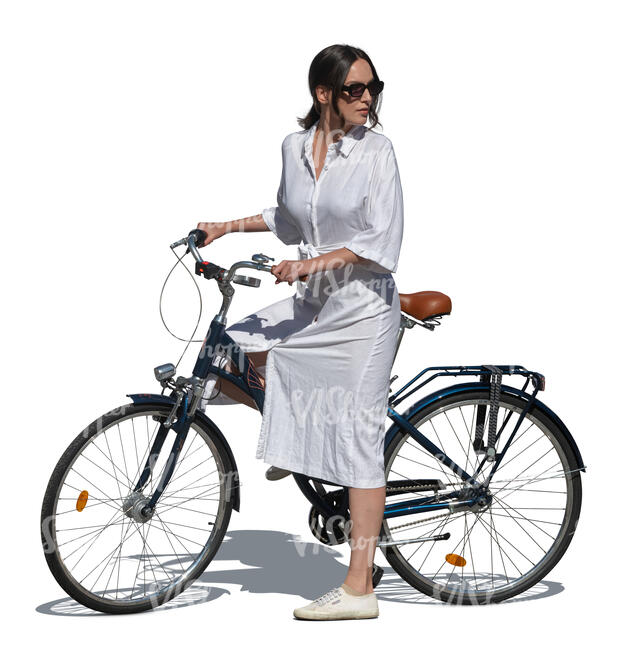 woman in a white summer dress standing with a bike