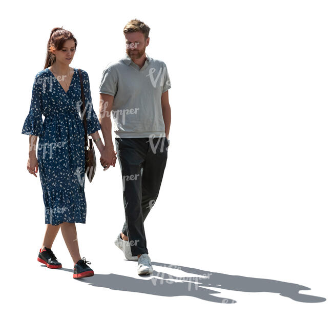 backlit couple walking hand in hand