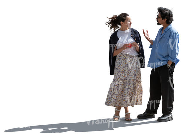backlit man and woman standing and talking lively