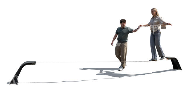 man supporting a woman walking on a slackline