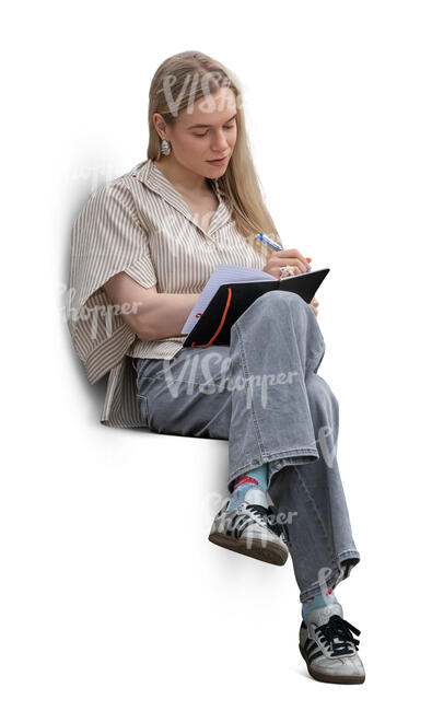 cut out woman sitting and writing in her notebook