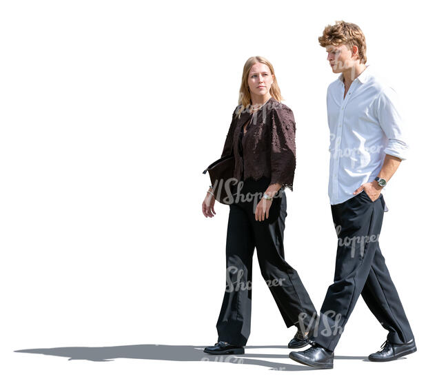 two sidelit people walking