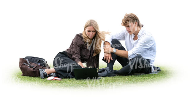 man and woman sitting on the grass and watching laptop together