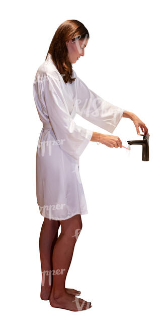 woman standing in the bathroom and brushing teeth