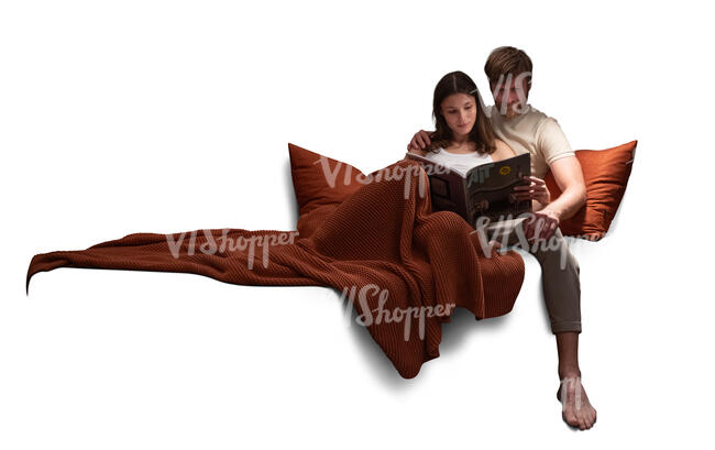 couple sitting on a sofa under a blanket and reading together