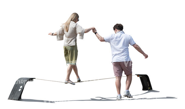 cut out woman walking on a slackline and a man is supporting her